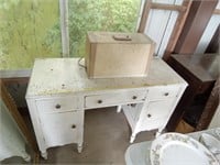 White sewing machine in cabinet