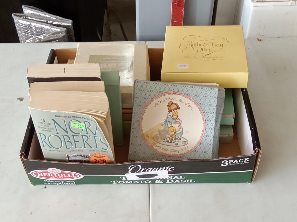 group of Avon plates in boxes