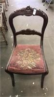 Vintage upholstered chair carved back
