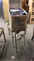Metal plant stand accent table and VHS tapes
