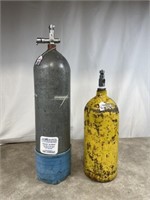 2 vintage scuba tanks, one is from 1950s