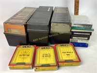 Assorted 8 track tapes with storage cases.
