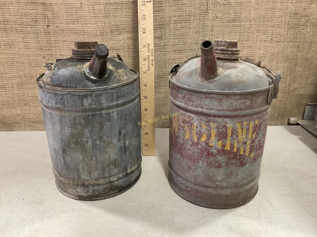 Two small galvanized gas cans. Have some dents