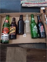 Assorted glass pop bottles