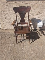 Vintage wooden pressed back chair with arms
