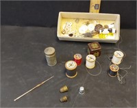 Metal thimbles, wood spools, buttons, metal