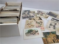 Full box of unsorted postcards and ephemera