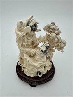 An ivory Carving of two ladis and boy holding (19h