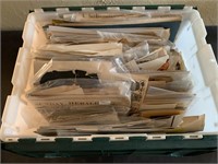 Tub full of unsorted paper ephemera, books