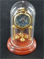 Miniature dome clock on a red jasper base with an