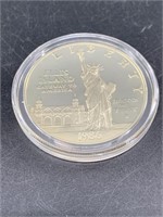 1986 S Ellis Island silver dollar in Mint case and