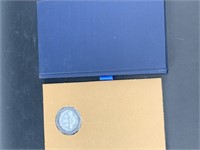 Silver coin and book from Indian Tribal series sig
