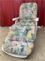 Classic plastic patio lounge chair with cushion.