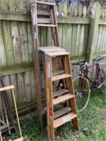 Three wooden step ladders