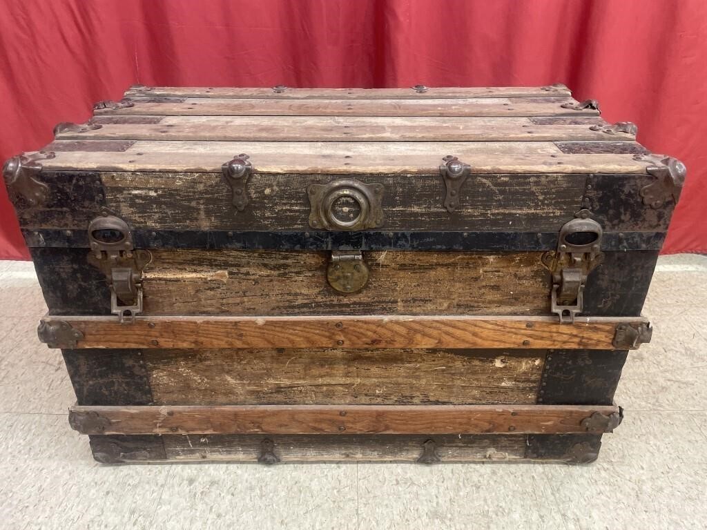 Vintage wooden steamer trunk with metal accents.