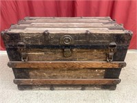 Vintage wooden steamer trunk with metal accents.