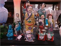 Eight Asian figurines of people and a bird from