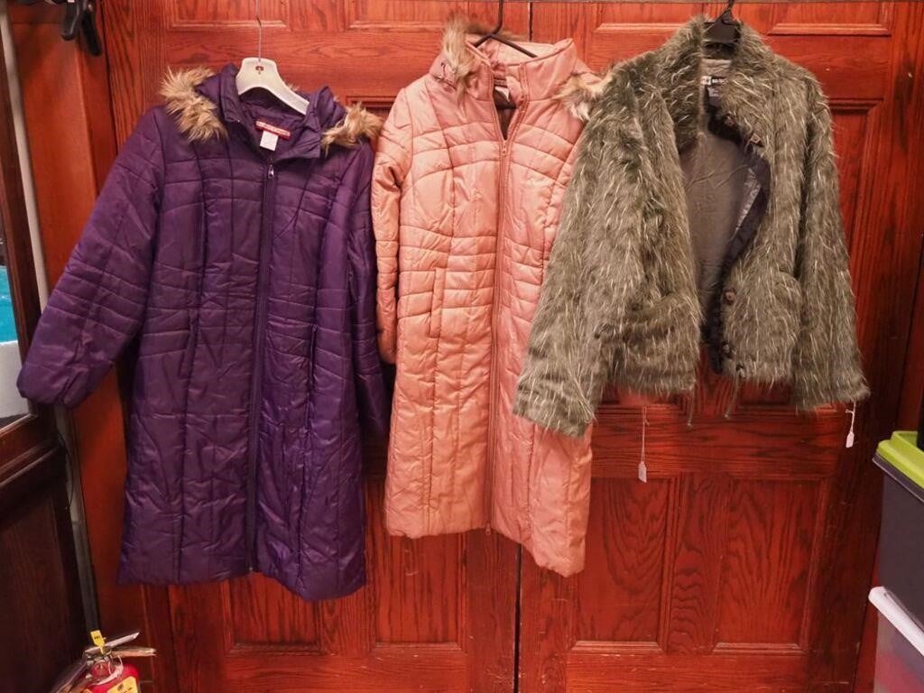 Three women's coats: two are long puff coats,