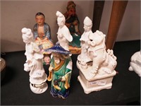 Seven figurines, all depicting Asian people; plus