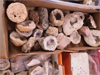 Container of various size geodes, quartz, rocks