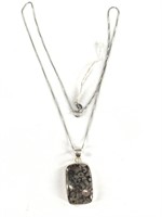 Polished stone in a sterling silver setting, bale