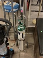Oxygen tank with rolling carrier.