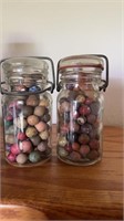 Two jars of antique clay marbles, these are small