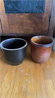 Two antique stoneware crocks, one with a dark