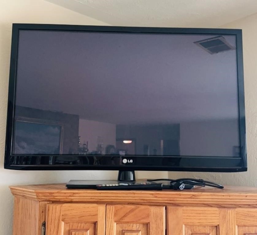 LG 42 inch flat screen TV on a stand, with the