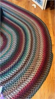Large colorful oval braided rug, measures about