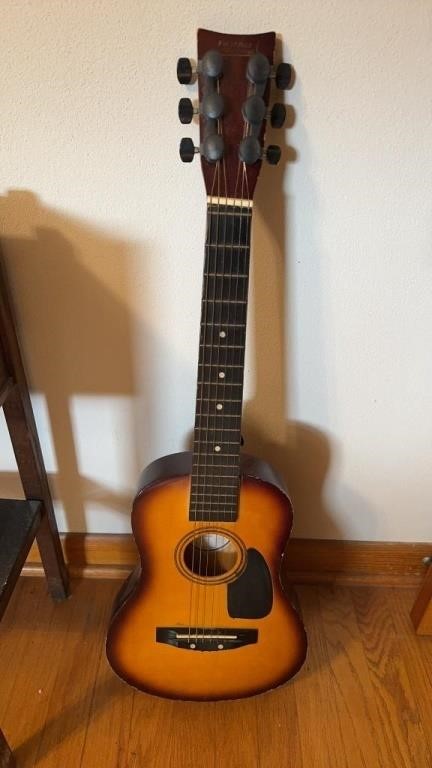 Child size 6 string guitar, by first act