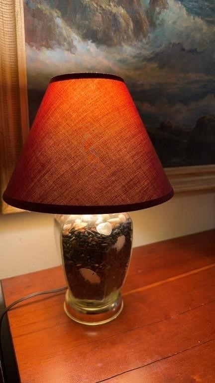 Glass table lamp filled with sharks teeth, sand