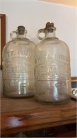Two White House vinegar jugs, a 1 gallon size a
