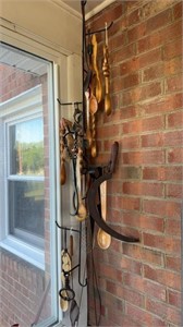 Metal hanger filled with carved wooden spoons,