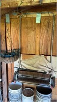 Yard sweeper and two metal hanging baskets in the