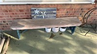 5 foot wood bench, and a sign, on the front porch