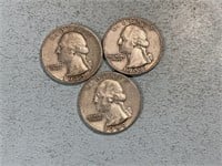 Three silver Washington quarters
