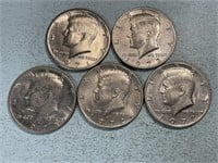 Five Kennedy half dollars