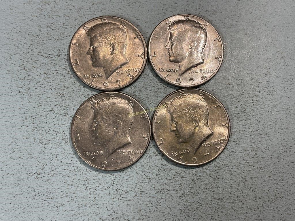 Four Kennedy half dollars