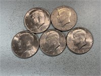 Five Kennedy half dollars