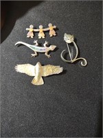Sterling pins featuring a cat, bird, gecko, kids.