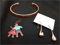 Copper bracelet, drop earrings and an enameled