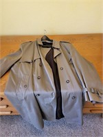 Gray trench coat and hanger