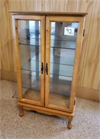 Lighted wood display cabinet with glass shelves
