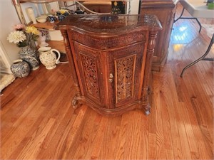 Ornate wooden cabinet with inlaid top
