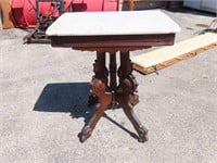 Eastlake style side table on casters. Marble top.