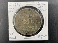 About 1934 Tunisian silver 20 francs, holed with X