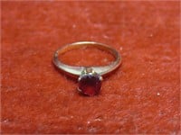 10k gold size 5.5 ring w/red stone.