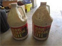 2 partial jugs of bar & chain oil