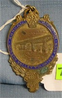 Antique brass and blue enameled badge